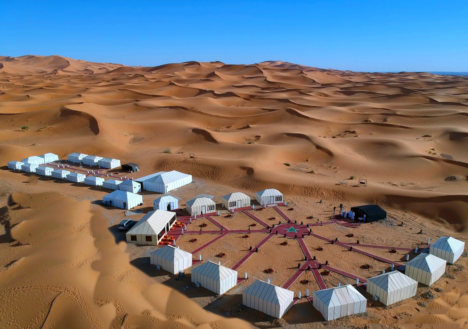 Aerial view of the Merzouga desert camp surrounded by the Erg Chebbi dunes